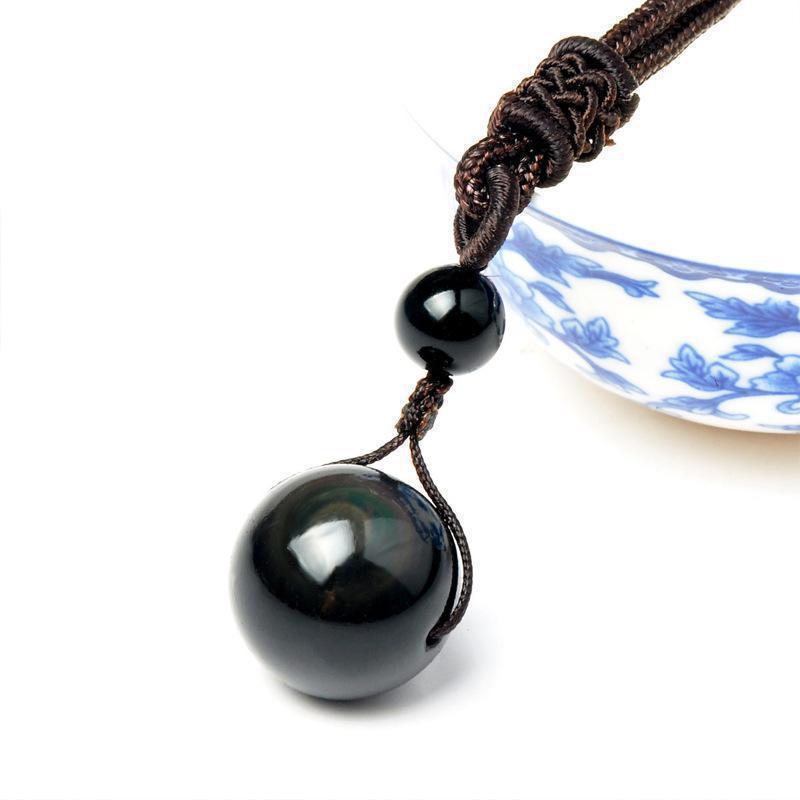 Natural obsidian bead necklace showing the celestial eye pattern