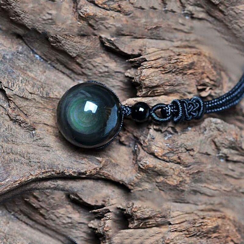 Obsidian celestial eye necklace on black waxed cord